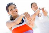 stock photo of fitness  - Group of fit women stretching outdoors and smiling - JPG 