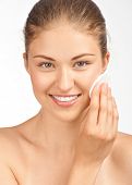 pic of close-up  - Portrait of young beautiful woman with cotton swab cleaning her face - JPG 