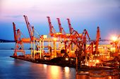 stock photo of portal  - Port warehouse with cargoes and containers at night - JPG 