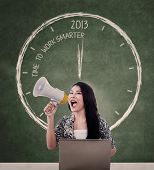 image of time  - Woman announcing time to work smarter in 2013 using megaphone - JPG 