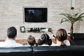 picture of home  - happy young family wathching flat tv at modern home indoor - JPG 