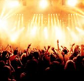 foto of rocks  - silhouettes of concert crowd in front of bright stage lights - JPG 