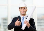 pic of construction  - Engineer in white hard hat hands layout and thumbs up - JPG 