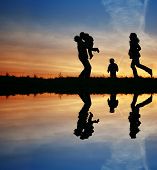 image of family  - silhouette family of four and water - JPG 