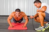 image of fitness  - fitness man and personal trainer in gym doing push - JPG 