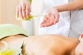 picture of woman  - Beautiful woman having a wellness back massage and feeling visibly good about it - JPG 