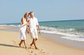 stock photo of beach  - Senior Couple Enjoying Beach Holiday - JPG 