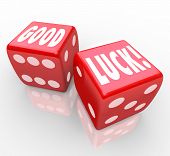 foto of outcome  - The words Good Luck on two red dice to encourage you to have good fortune and a favorable outcome in a game or effort - JPG 