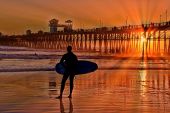 pic of watch  - A silhouetted surfer watches and waits for the perfect set and gains inspiration from another Southern California sunset - JPG 