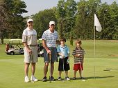 foto of golf  - Two Generations of Family Playing Golf Together - JPG 