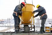 image of construction  - construction building workers at construction site pouring concrete in form - JPG 