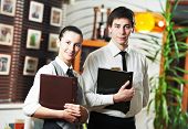 picture of restaurant  - Waitress girl and waiter man of commercial restaurant in uniform waiting an order with menu - JPG 