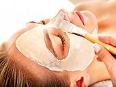 foto of facial  - Woman with clay facial mask in beauty spa - JPG 