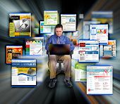 foto of zoom  - a business man is sitting on a black background and is working on a laptop computer - JPG 