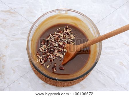 Stirring Chopped Pecan Nuts Into Filling For Pecan Pie