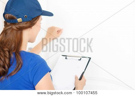 Nice deliverywoman standing near door