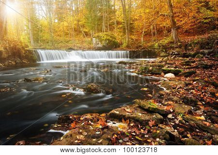waterfall with a shining sun