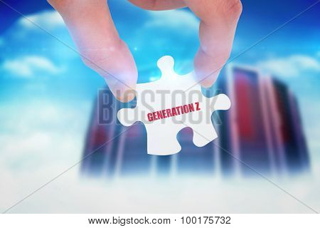 The word generation z and hand holding jigsaw piece against composite image of server towers