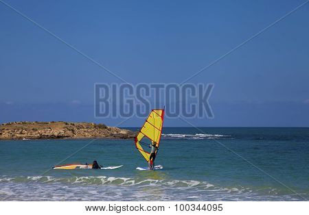 Female Windsurfers In The Sea