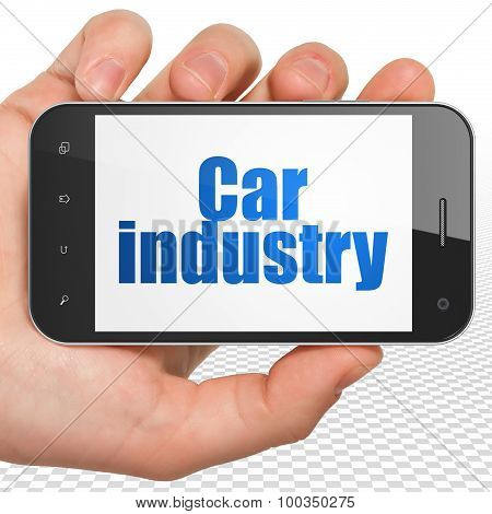 Manufacuring concept: Hand Holding Smartphone with Car Industry on display