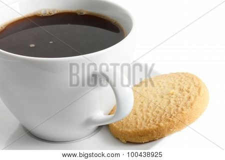 Detail Of A White Ceramic Cup Of Black Coffee With Shortbread Biscuit.
