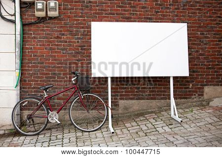 Blank Advertisement Board At Street With Bicycle Next To It