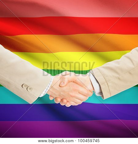 Businessmen Handshake With Flag On Background - Lgbt People
