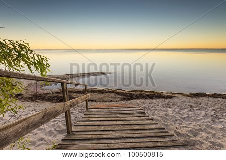 Landscape With Wooden Stairs Leading To The Sea