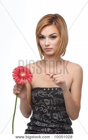 Portrait Of A Young Woman Picking Pettals From A Flower, Looking Sad