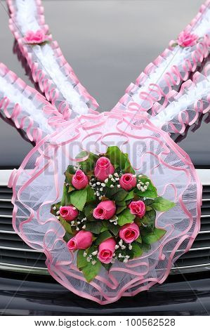 Wedding bouquet of roses on a car cowl