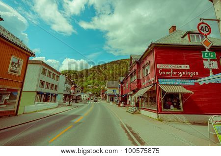 VALDRES, NORWAY - 6 JULY, 2015: Charming town of Fagernes with small city buildings sorrounded by gr