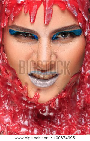 portrait of a beautiful girl bathed in red wax
