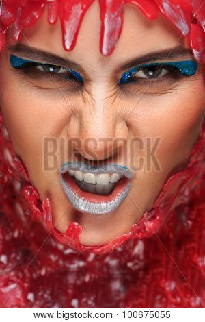 portrait of a beautiful girl bathed in red wax