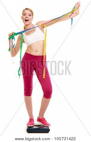 Happy Woman With Tape Measures On Weighing Scale.