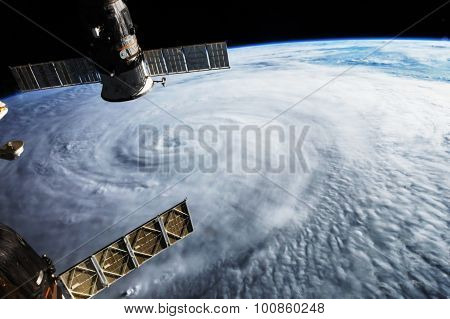 Satellite above hurricane on earth. Some graphics are provided by NASA.