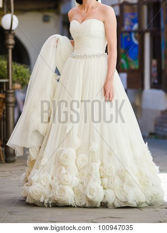 Bride, row of bridesmaids with bouquets at big wedding ceremony.