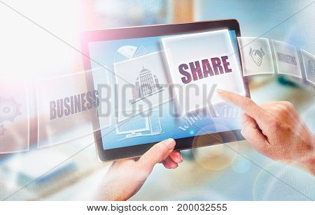 A businesswoman selecting a Share business concept on a futuristic portable computer screen.