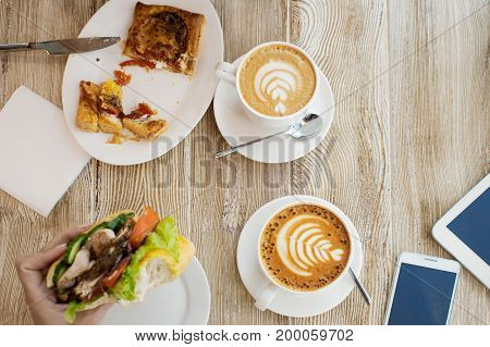 Two Cups Of Coffee, Friendly Atmosphere. Chicken Sandwich, Cup Of Coffee And Smartphone On The Table