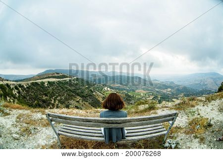 Woman sitting on bench in cyprus mountains