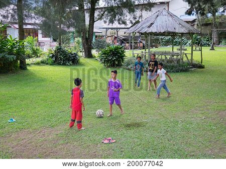 BERASTAGI INDONESIA 15 MAY 2017 : Indonesian children play football in countryside area of Berastagi city Northern Sumatra.
