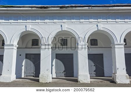 Old white arches. Grey gates and windows