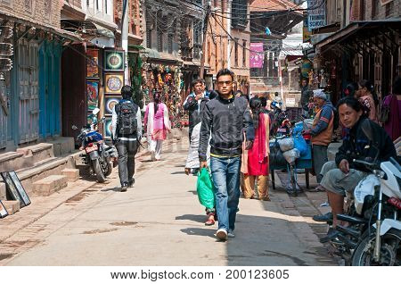 Kathmandu Nepal - March 9 2013: Crowd of people in the alley of Thamel street. Thamel is a commercial neighbourhood in Kathmandu the capital of Nepal.