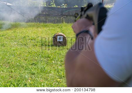 A Man Shoots A Target From A Pneumatic Gun. A View From Behind The Shoulder