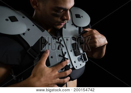 Close-up of American football player wearing a shoulder pad