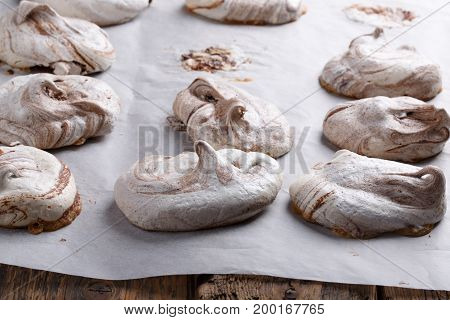 Homemade marble chocolate meringue cookies on a baking sheet