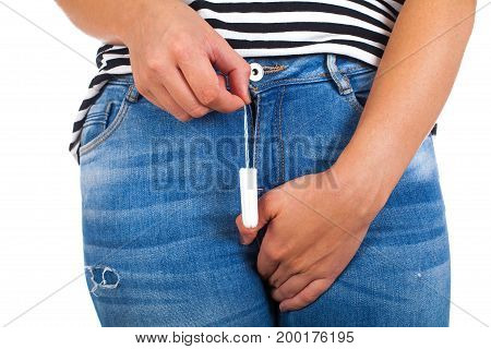 Close up picture of young woman with casual outfit holding a menstruation tampon on isolated background