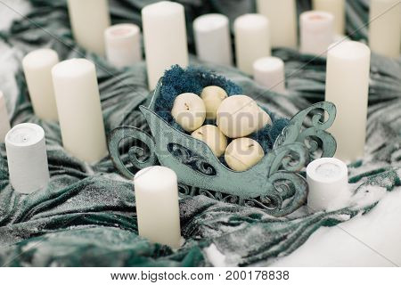 decorate cbeautiful andles with winter flowers and snow