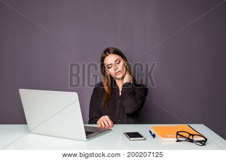 Businesswoman In Office Working With Laptop. Woman Sitting At Her Working Desk Hands On Her Neck Of