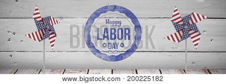 Digital composite of Happy labor day text and USA wind catchers in front of wood