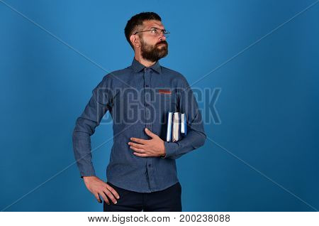Teacher With Glasses And Notebooks. Man With Beard And Books